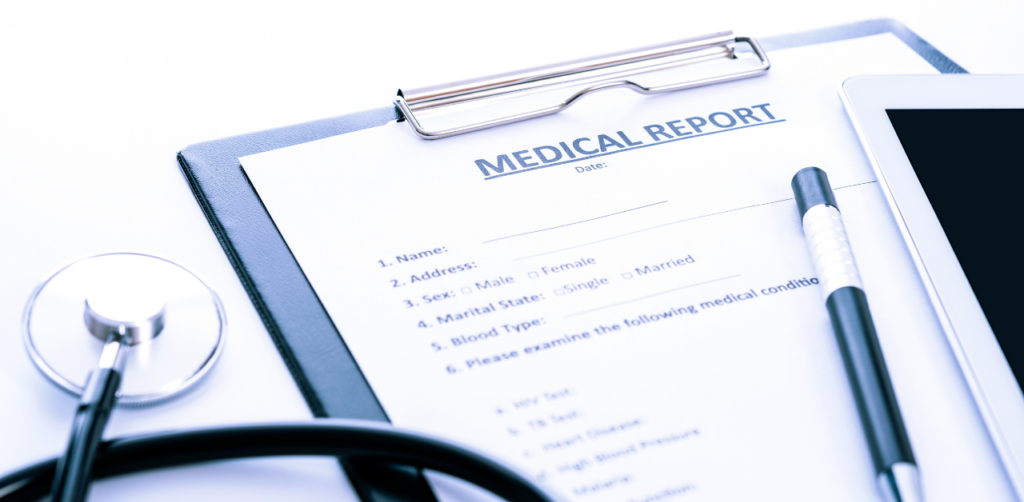 Medical report form on a clipboard with stethoscope, pen, and tablet, ready for patient details