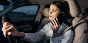 Woman talking on phone while driving at night, unsafe driving behavior
