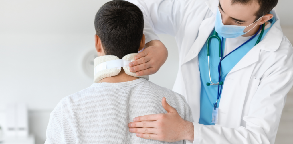 A doctor adjusting a neck brace on a man facing away in a medical examination room