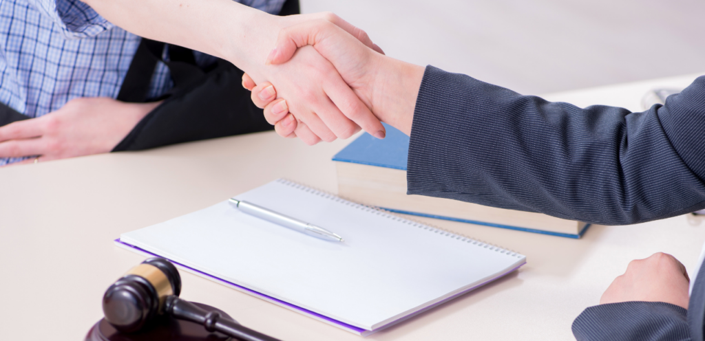 Injured person shaking hands with attorney