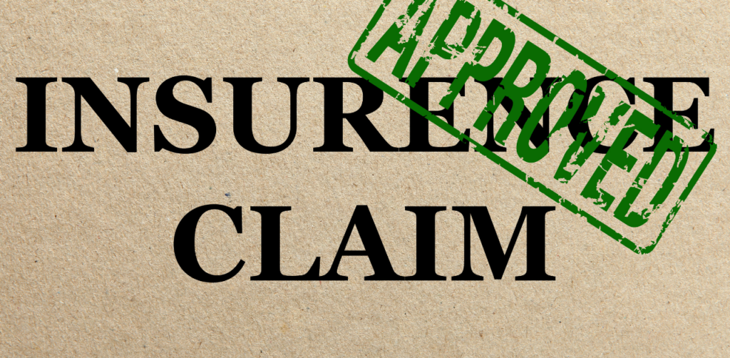 The words INSURED CLAIM stamped with APPROVED in bold green letters, indicating approval of an insurance claim