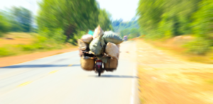 Motorbike Overloaded with Goods on a Rural Road