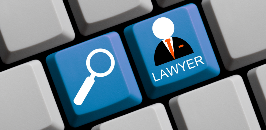 Computer keyboard with blue keys featuring a magnifying glass icon and the word Lawyer with an illustrated figure
