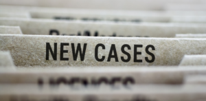 File folders with a visible tab labeled New Cases in bold black letters