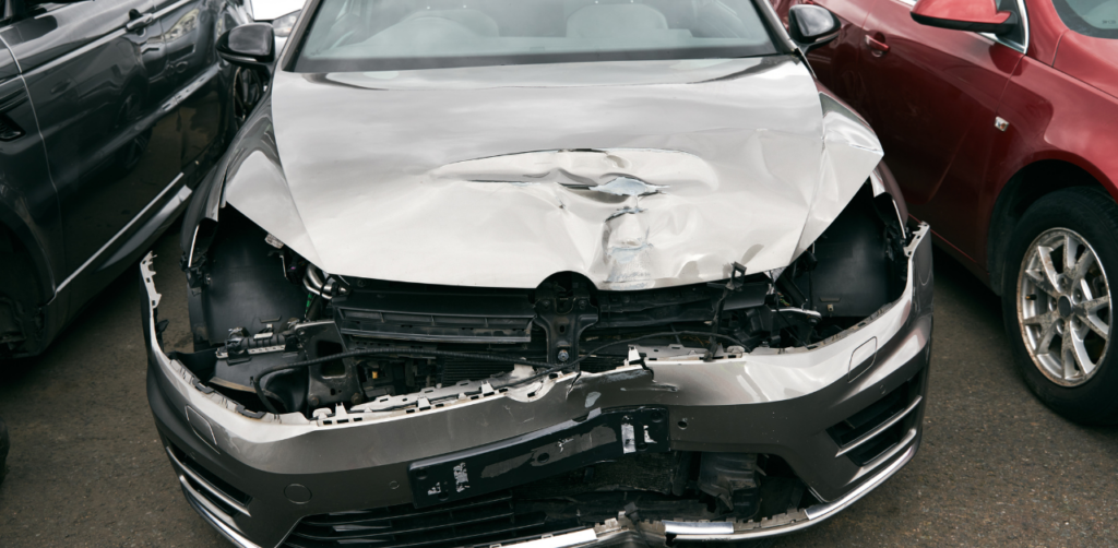 Heavily damaged car, suggesting a severe accident or collision