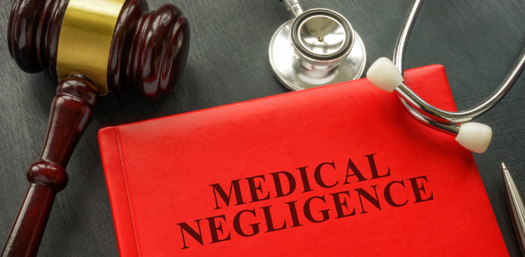 Medical Negligence book with a gavel and stethoscope, representing legal and medical malpractice issues