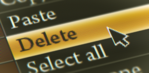 Close-up of a computer screen with a cursor hovering over a highlighted Delete option in a dropdown menu