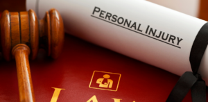 Gavel resting on a red law book next to a scroll labeled Personal Injury