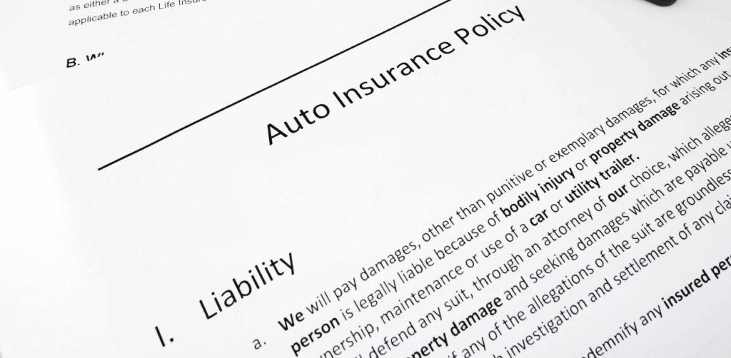 Close-up of an auto insurance policy document showing liability coverage details