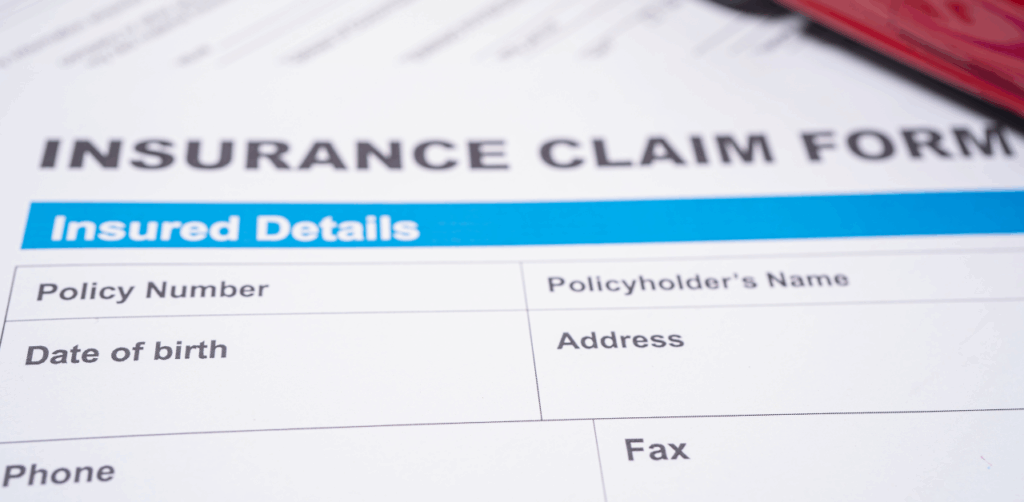 Close-up of insurance claim form showing fields for policyholder's personal details