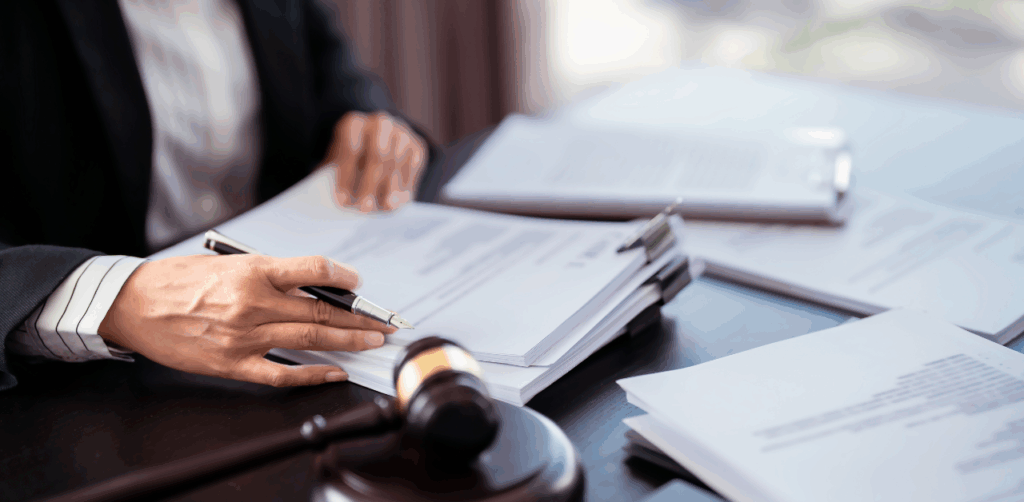 Lawyer reviewing legal documents at desk with gavel, preparing case paperwork
