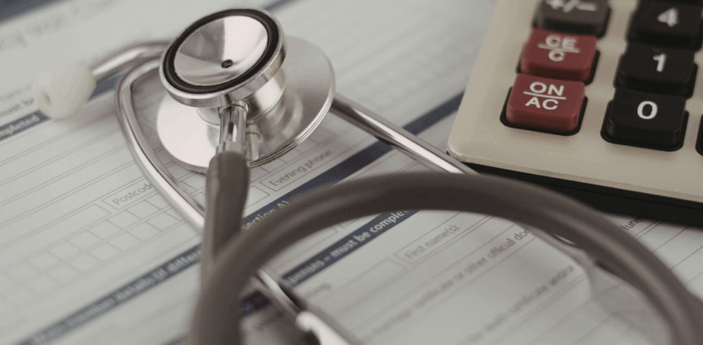 Stethoscope and calculator rest on a medical form, highlighting healthcare costs
