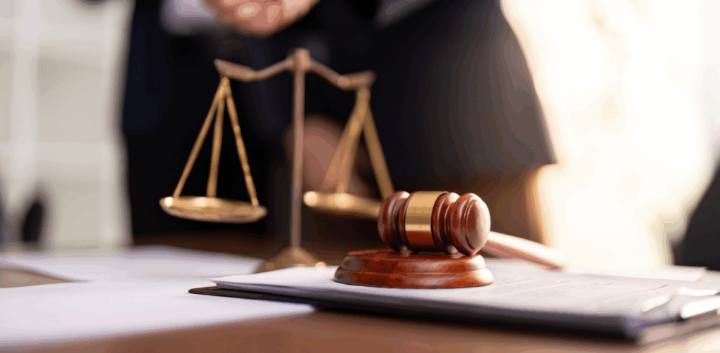 Close-up of a gavel and scales of justice in a courtroom setting