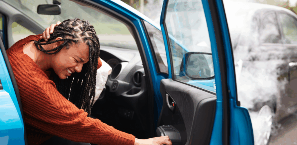 Injured woman holding her neck after a car accident, in visible pain
